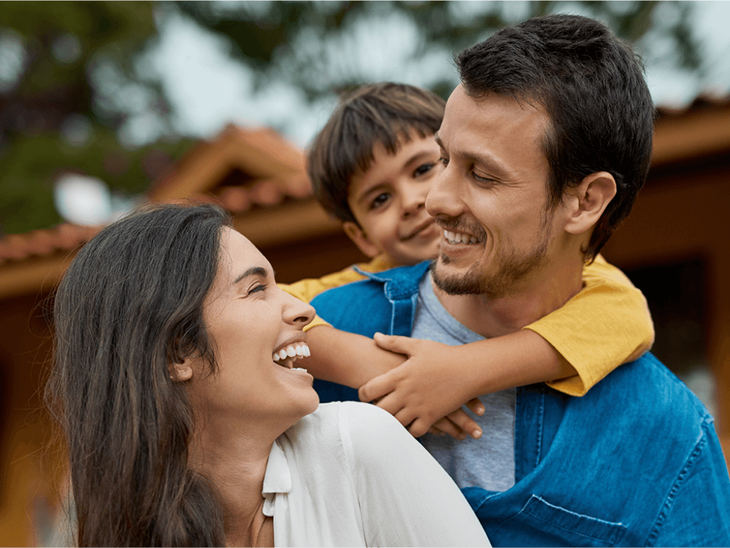 Happy family in front of their new home